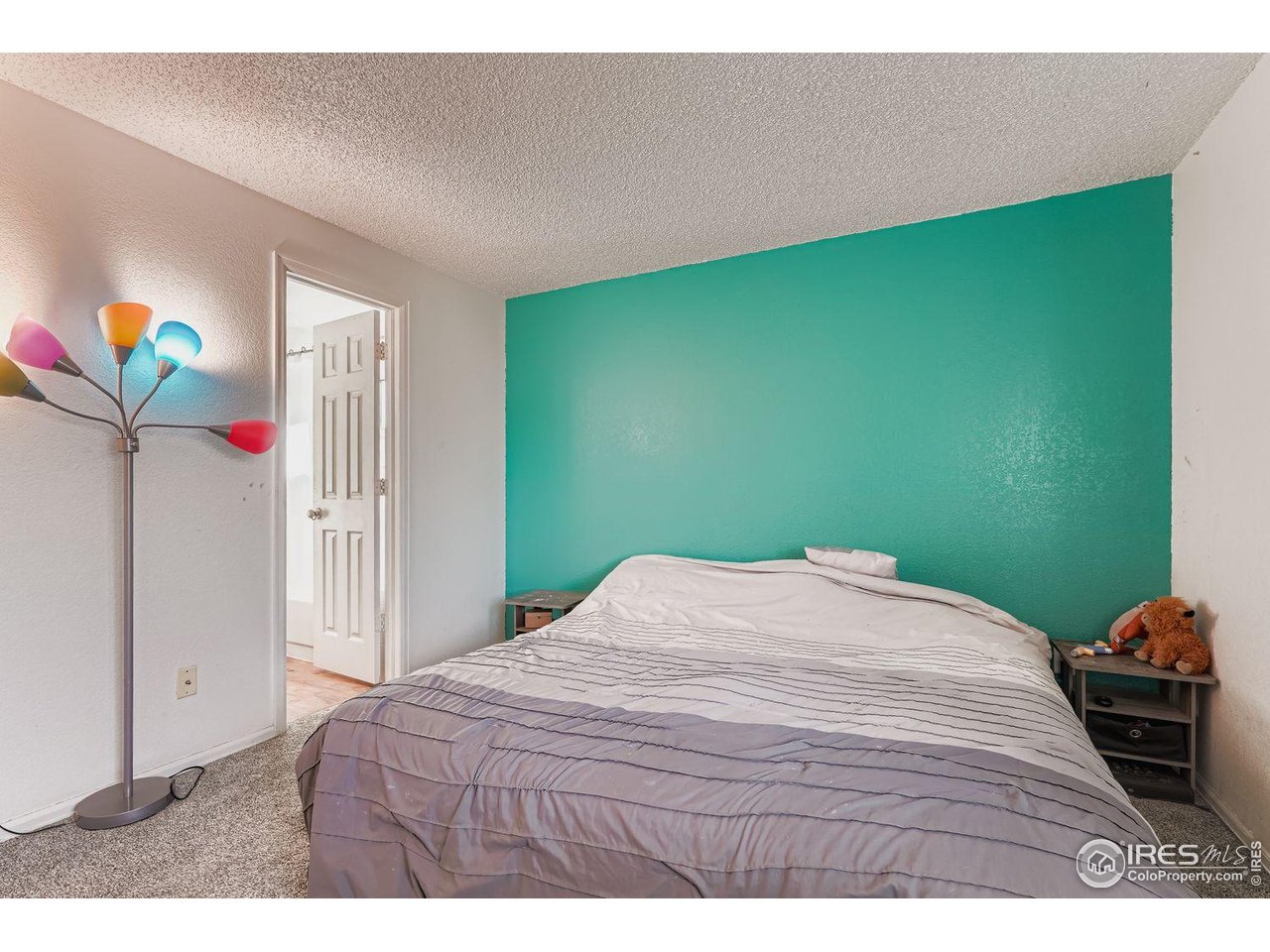 12129 Forest Street Thornton, CO 80241 - Photo 10 of 19 a bedroom with a bed and a window