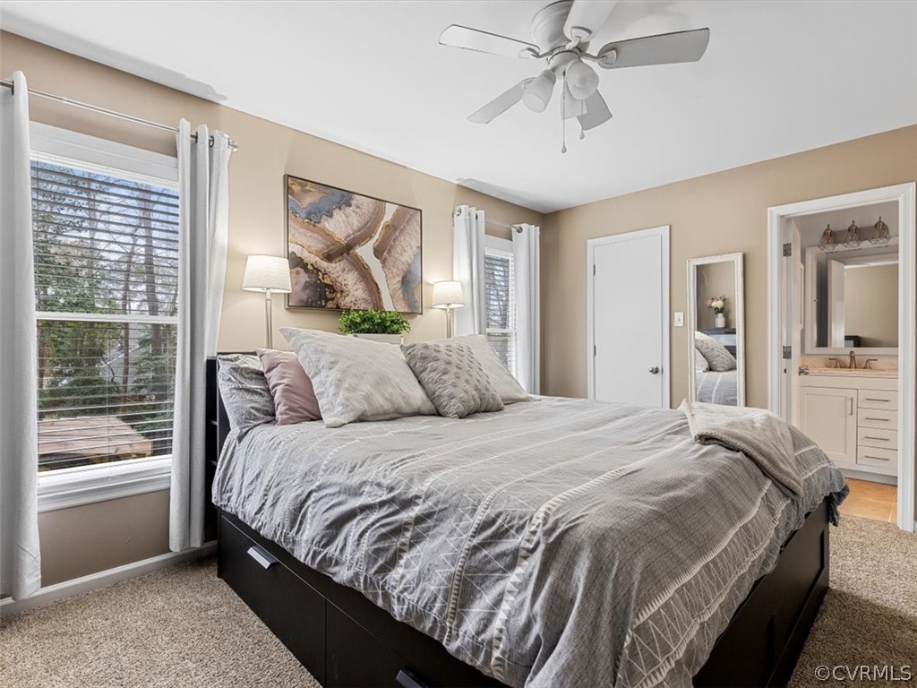 4408 Rabbit Foot Court Chesterfield, VA 23236 - Photo 10 of 36 a bedroom with a large bed and a chandelier