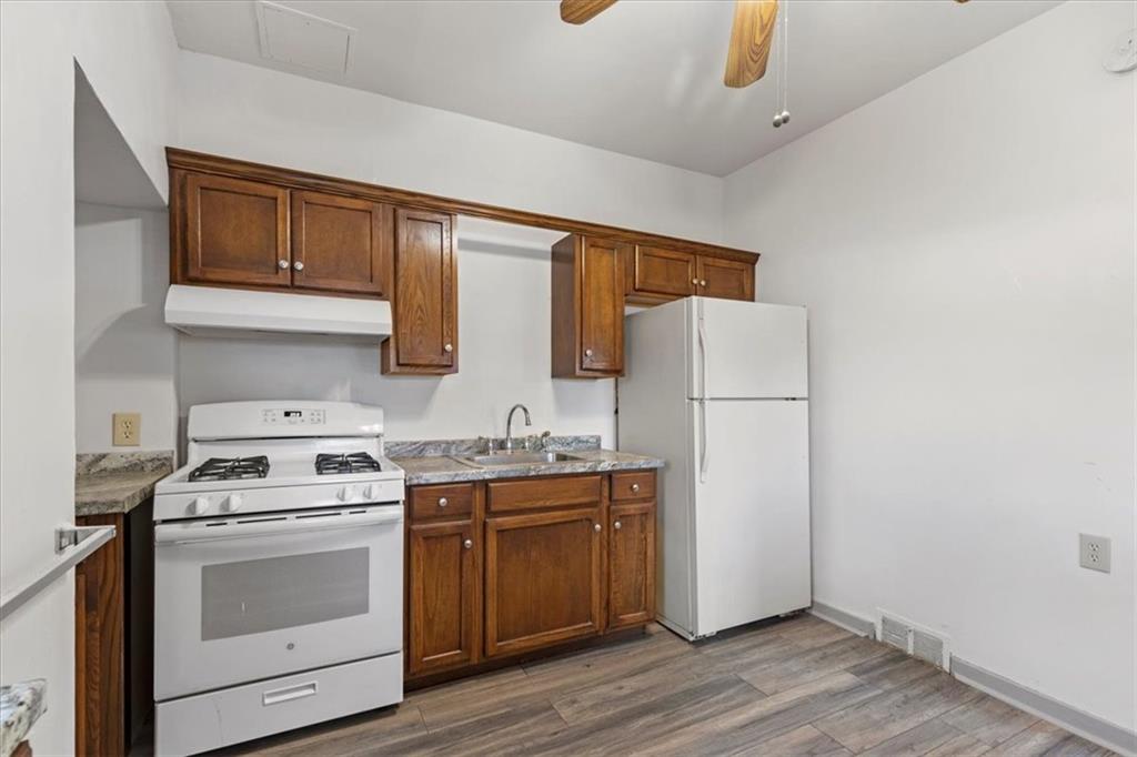405 Walter Street Pittsburgh, PA 15210 - Photo 13 of 40 a kitchen with a stove a sink and a refrigerator