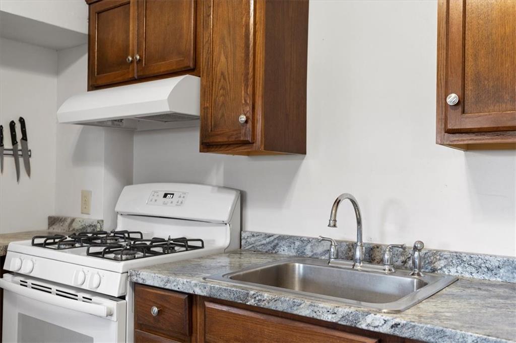 405 Walter Street Pittsburgh, PA 15210 - Photo 14 of 40 a kitchen with granite countertop a stove and a sink