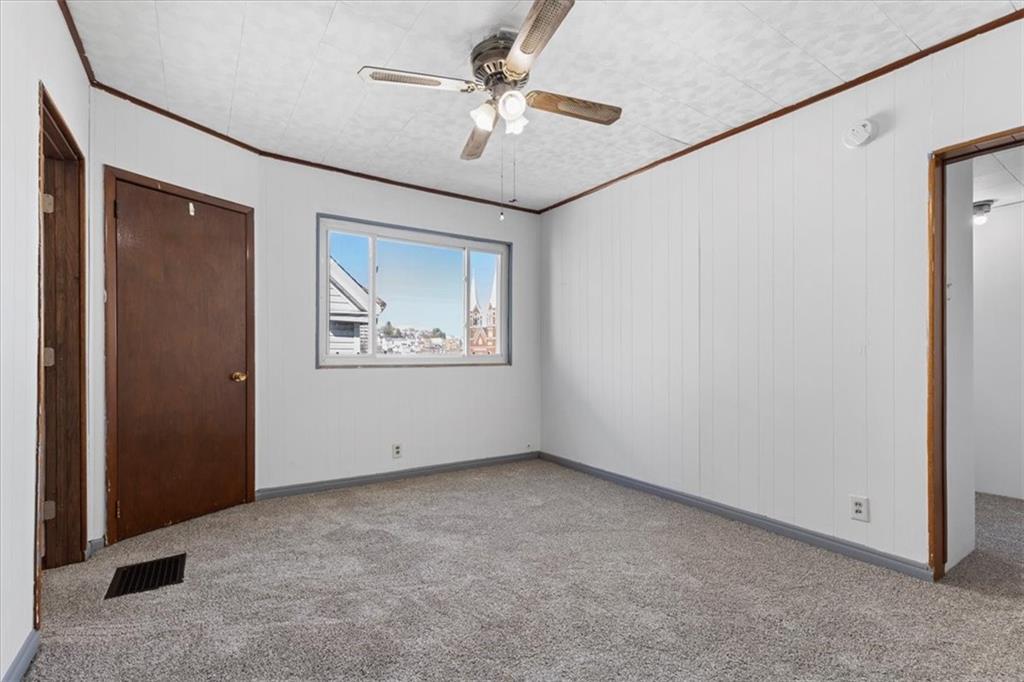 405 Walter Street Pittsburgh, PA 15210 - Photo 19 of 40 an empty room with windows and fan