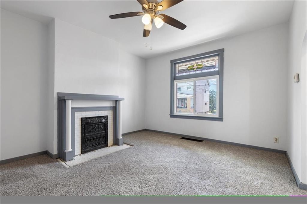 405 Walter Street Pittsburgh, PA 15210 - Photo 6 of 40 an empty room with fireplace and fan