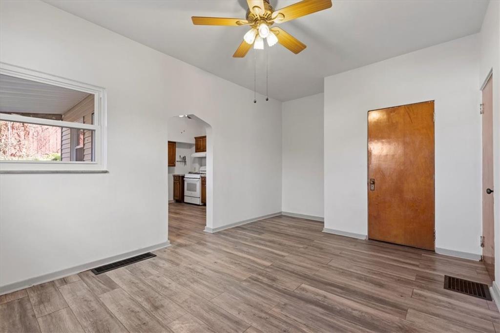 405 Walter Street Pittsburgh, PA 15210 - Photo 10 of 40 a view of an empty room with wooden floor and a ceiling fan