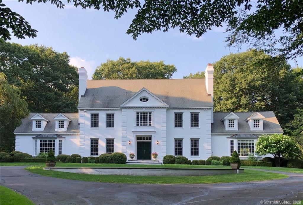 exterior front with circular driveway and professional landscaping