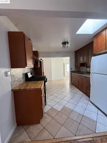 a kitchen with stainless steel appliances granite countertop a refrigerator stove and a sink