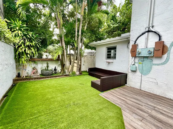 a view of a backyard with sitting area