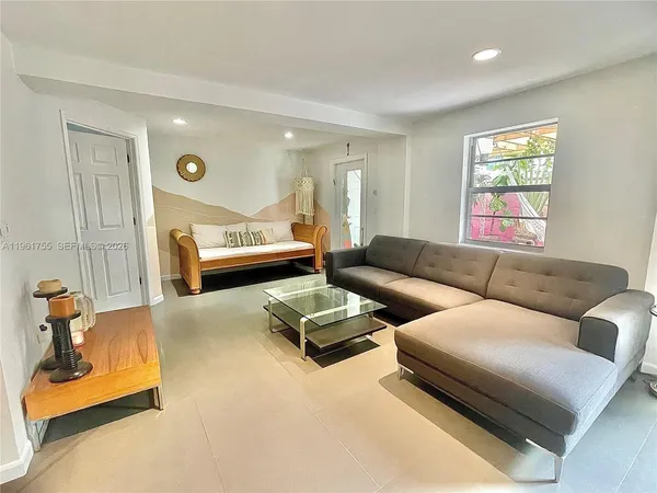 a living room with furniture and a rug