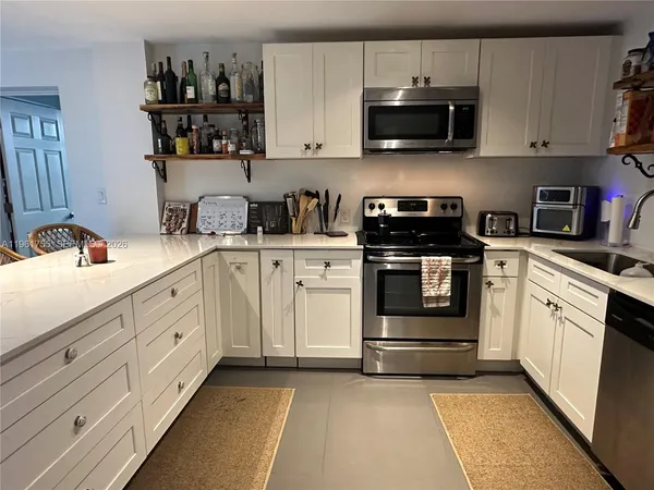 a bedroom with a large bed and a flat screen tv