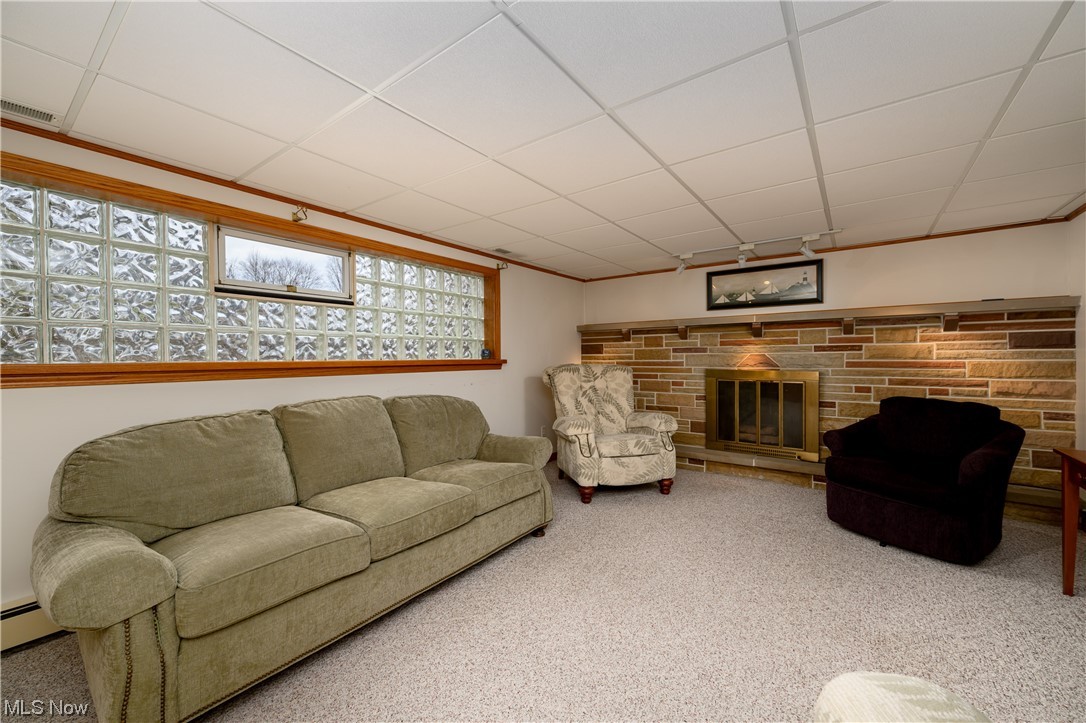 5304 Sibila Road Northwest Canton, OH 44718 - Photo 28 of 29 Carpeted living room with a drop ceiling and a stone fireplace