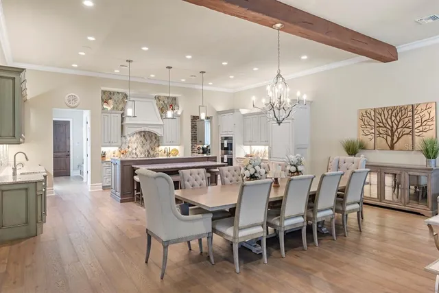 a dining room with furniture and chandelier
