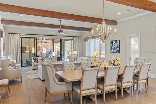 a spacious bedroom with a bed a couch and a chandelier