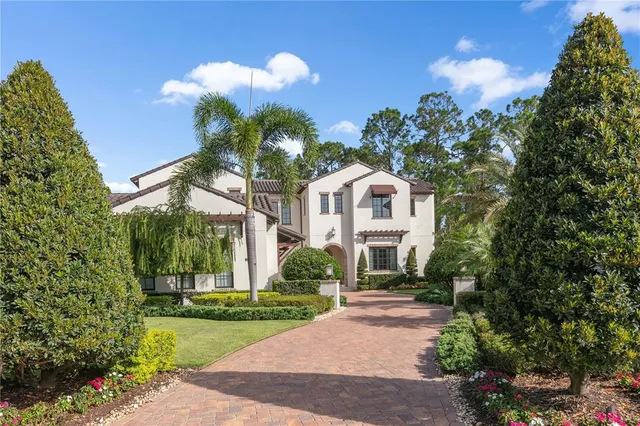a front view of a house with a yard and a garden