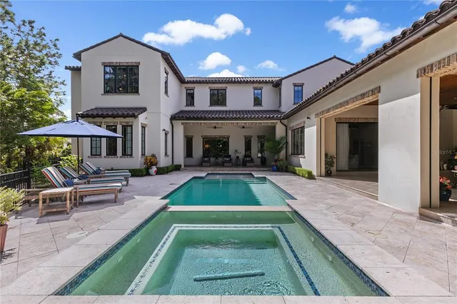 a view of a patio with swimming pool table and chairs