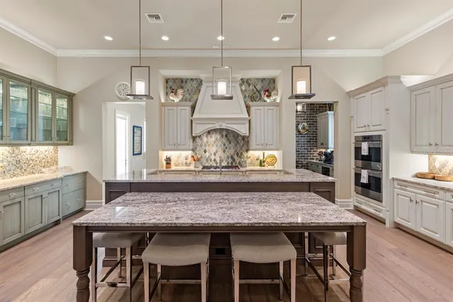 a kitchen with kitchen island granite countertop wooden floor refrigerator and center island