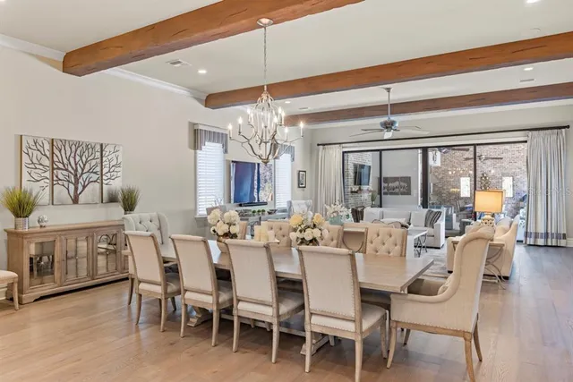 a living room with furniture a flat screen tv and a large window