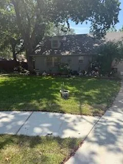 a backyard of a house with lots of green space and fountain