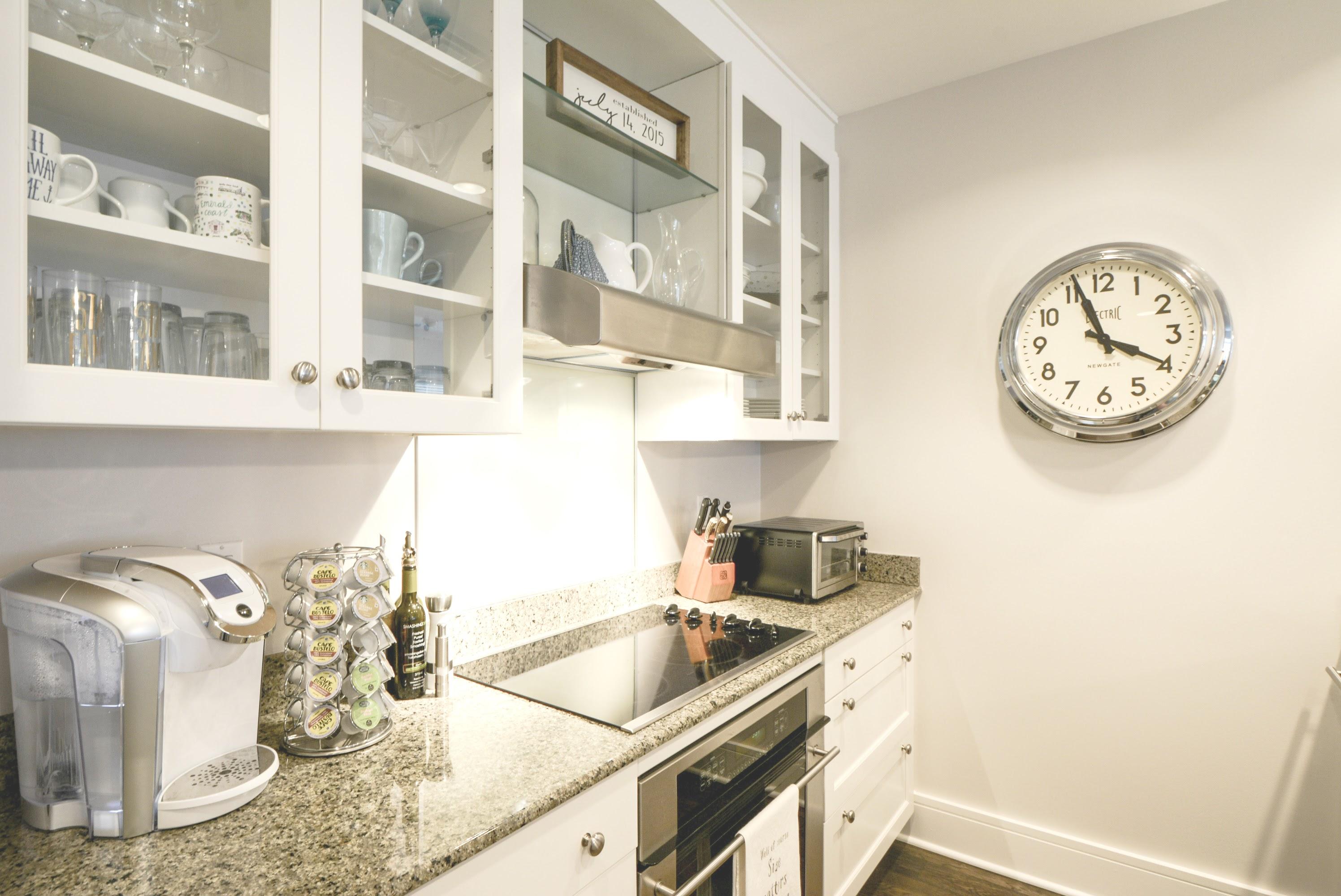 99 Compass Point Way South, Unit 201 Inlet Beach, FL 32461 - Photo 17 of 56 a kitchen with a stove and a clock on the wall