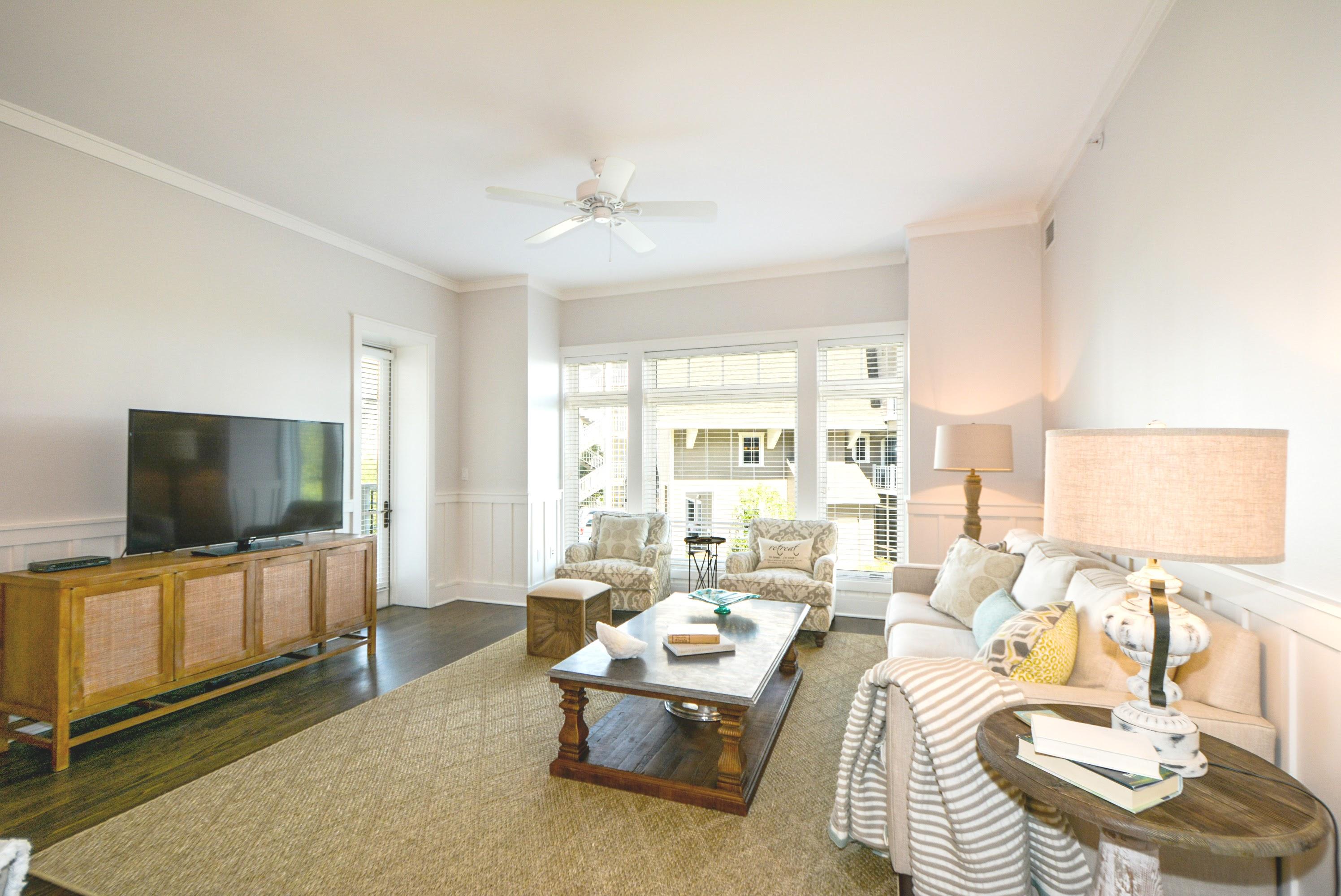 99 Compass Point Way South, Unit 201 Inlet Beach, FL 32461 - Photo 4 of 56 a living room with furniture and a flat screen tv