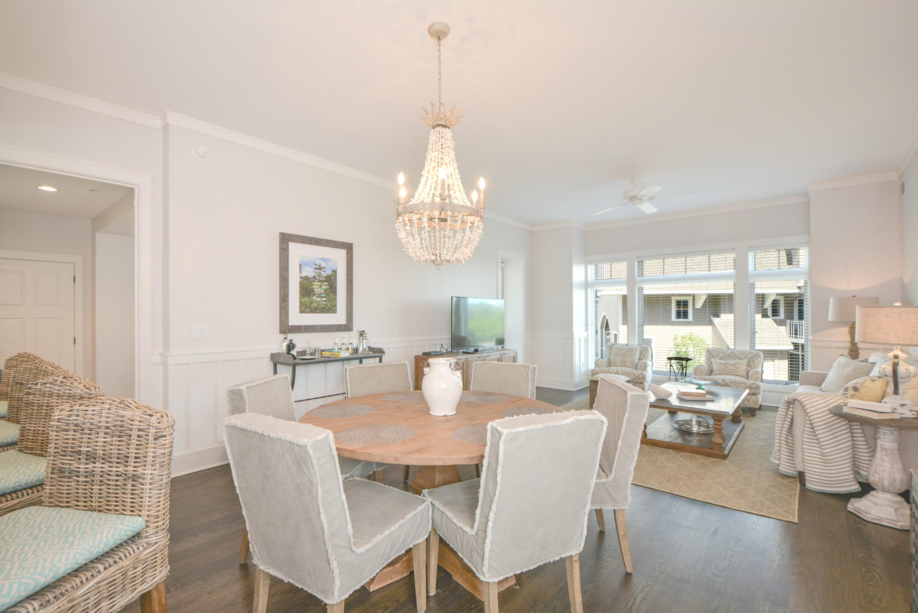 99 Compass Point Way South, Unit 201 Inlet Beach, FL 32461 - Photo 7 of 56 a dining room with wooden floor a chandelier a wooden table and chairs