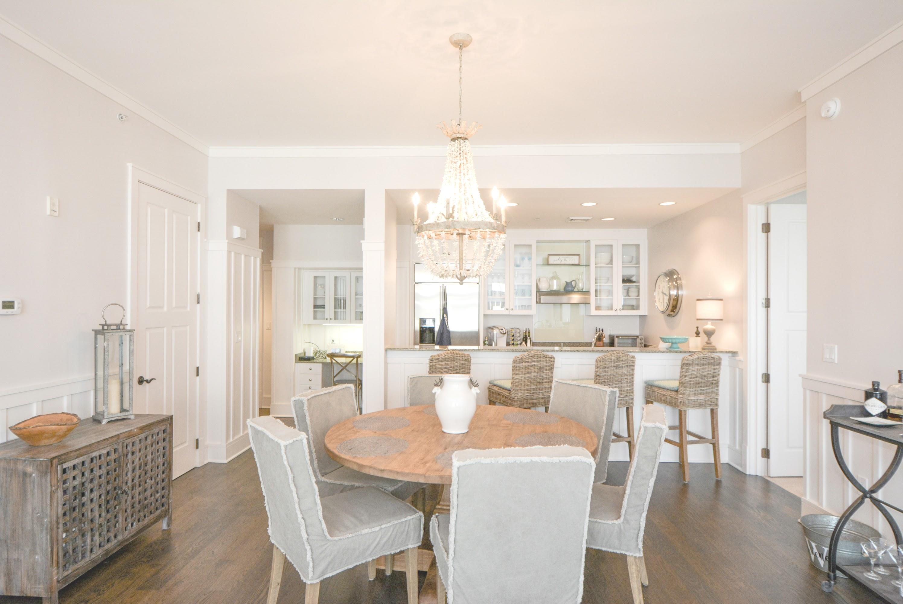 99 Compass Point Way South, Unit 201 Inlet Beach, FL 32461 - Photo 8 of 56 a dining room with furniture a chandelier and wooden floor