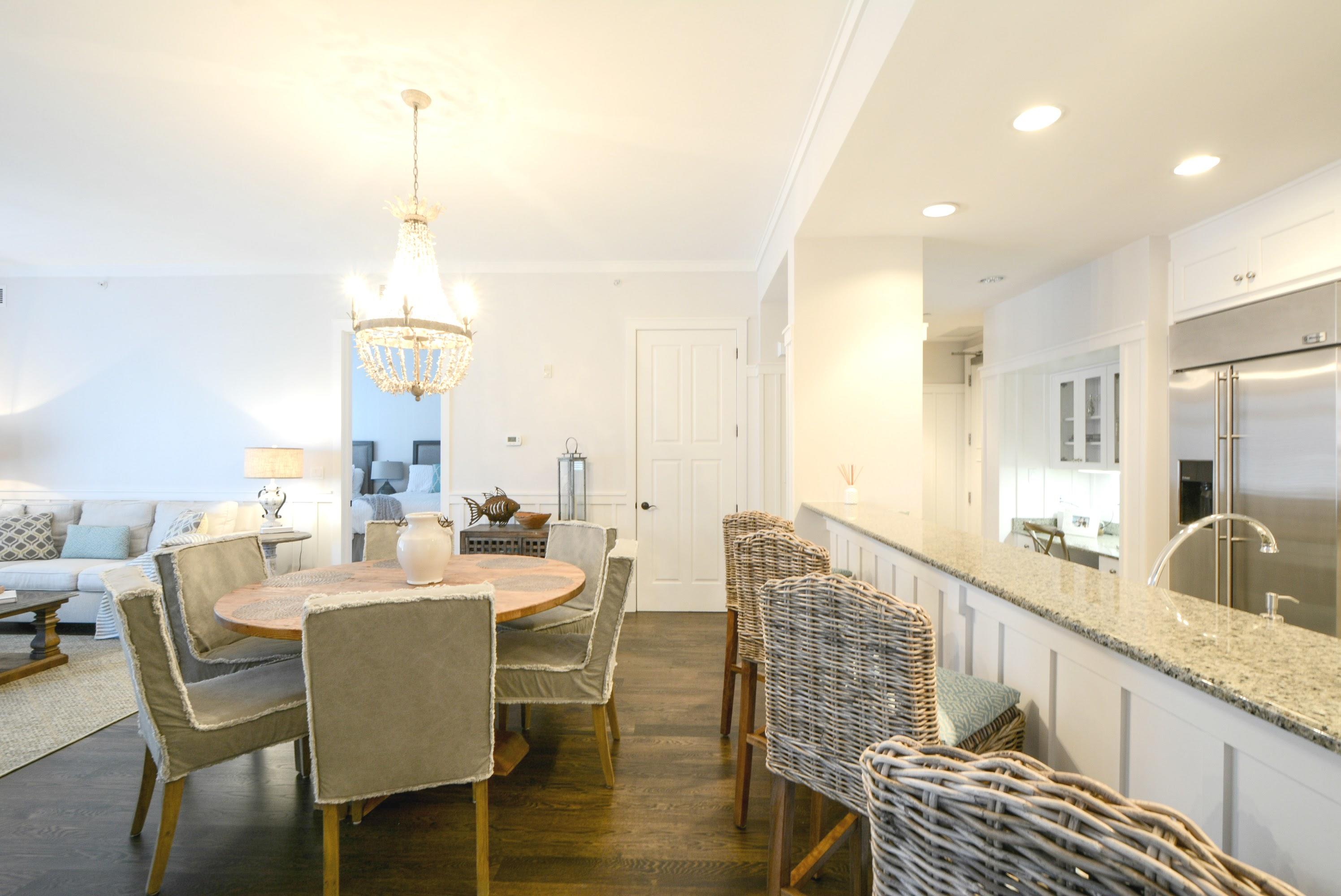 99 Compass Point Way South, Unit 201 Inlet Beach, FL 32461 - Photo 9 of 56 a view of a dining room and livingroom with furniture wooden floor a rug a fireplace and a chandelier