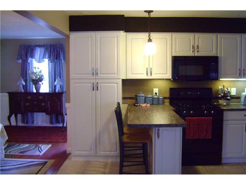 959 Harper Road Crescent, PA 15046 - Photo 2 of 24 Kitchen. Updated white kitchen cabinets, newer counter top, neutral ceramic tile flooring, black appliances included. Great breakfast counter for casual dining.