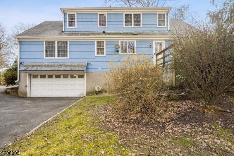 37 Evergreen Road Summit, NJ 07901 - Photo 27 of 28 a front view of a house with a yard and garage