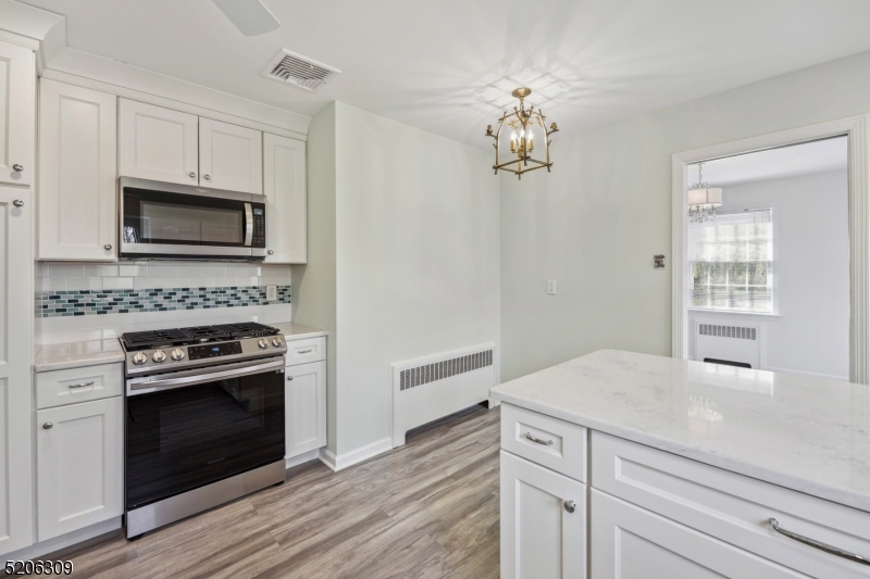 37 Evergreen Road Summit, NJ 07901 - Photo 4 of 28 a kitchen with cabinets stainless steel appliances and wooden floor