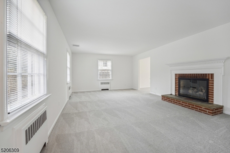 37 Evergreen Road Summit, NJ 07901 - Photo 6 of 28 a view of an empty room with a fireplace and a window