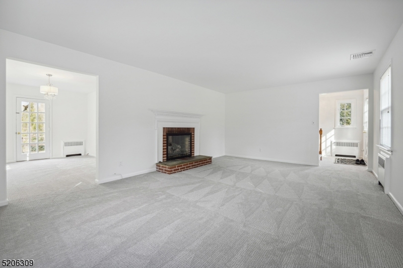 37 Evergreen Road Summit, NJ 07901 - Photo 7 of 28 a view of empty room with fireplace and wooden floor