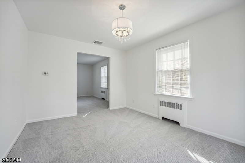 37 Evergreen Road Summit, NJ 07901 - Photo 9 of 28 an empty room with a windows and chandelier fan
