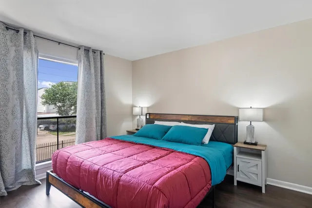 a bedroom with a bed and a lamp