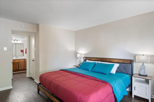 a bedroom with a bed and a view of kitchen