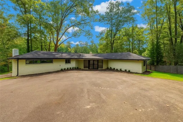 a view of a house with pool and a fire pit