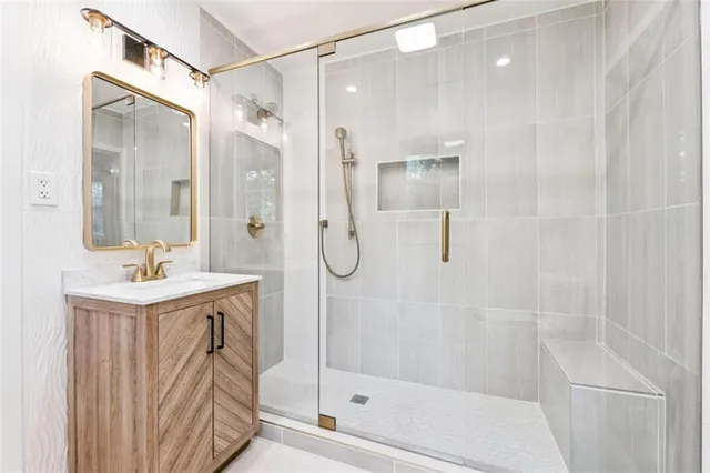 a bathroom with a shower sink and mirror