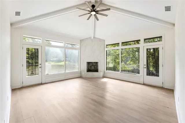 a view of a room with furniture wooden floor potted plants and a chandelier