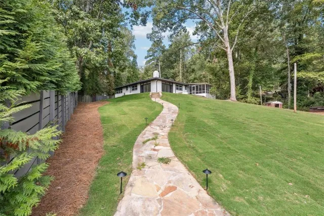a view of a backyard with large trees
