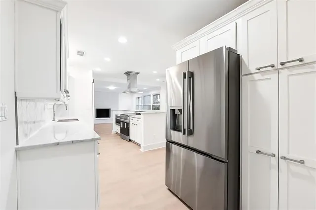 a kitchen with stainless steel appliances a refrigerator sink and cabinets