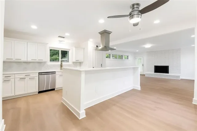 a kitchen with kitchen island a stove a sink and a refrigerator
