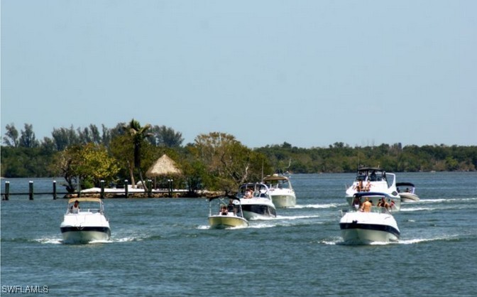 Little Shell Island Fort Myers, FL 33908 - Photo 6 of 26 a view of a swimming pool and lounge chairs