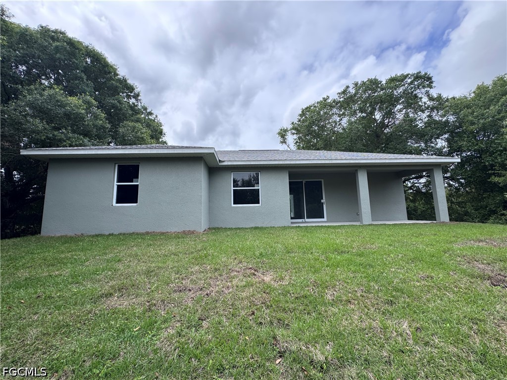 915 Marconi Loop LaBelle, FL 33935 - Photo 2 of 6 a front view of house with yard and trees