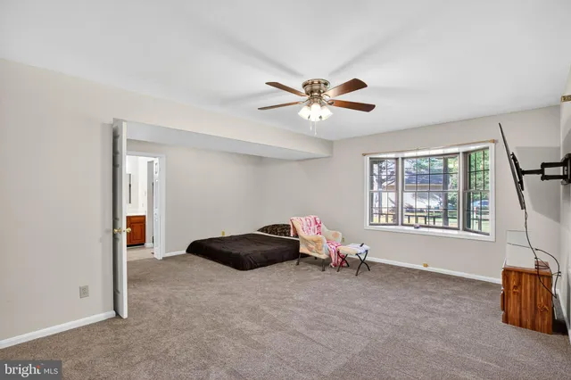 a spacious bedroom with a bed and a chandelier