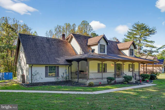 a view of a brick house with a yard garden and plants