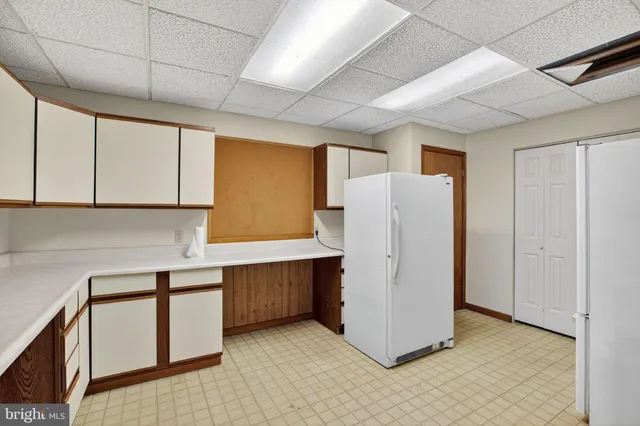 a room with refrigerator and window