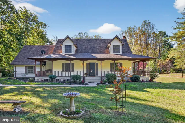 a front view of a house with a yard table and chairs