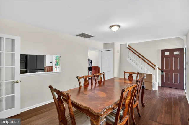 a dining room with furniture and wooden floor