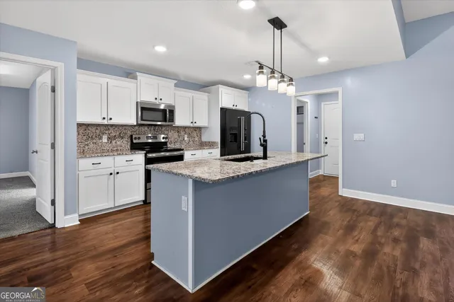 a kitchen with kitchen island microwave and cabinets
