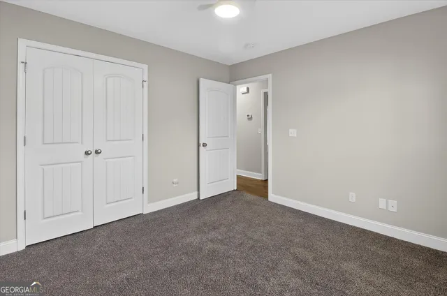 a view of an empty room and closet area