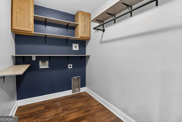 a view of walk in closet with empty racks