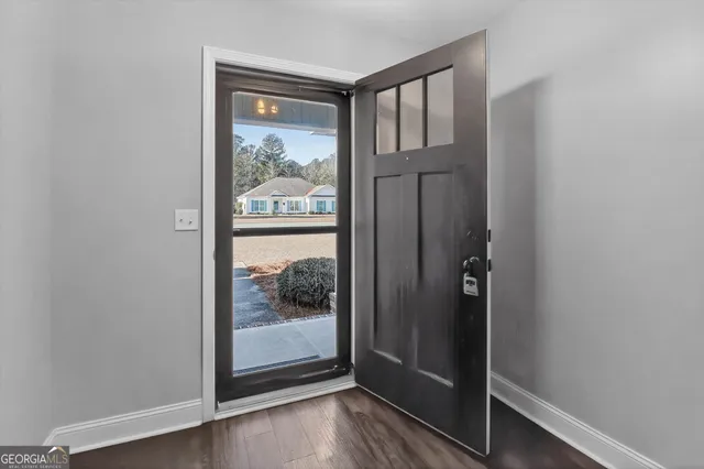 a view of a glass door with wooden floor